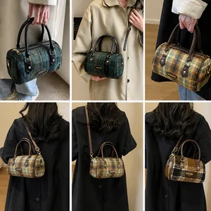 Detail view of plaid Boston bag showing dual handles and detachable strap options