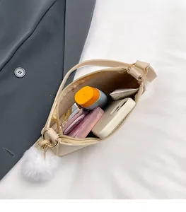Top view of beige felt crossbody bag showing interior space for phone and cosmetics
