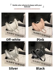 Modern half-moon underarm bags shown in cream, pink, silver and black leather