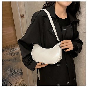 Minimalist white hobo bag with glossy finish shown on model for elegant shoulder wear