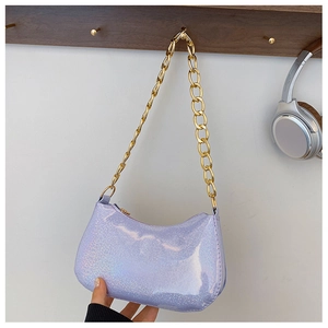 Detail of lavender laser-finish hobo bag with thick gold chain on a wooden hanger