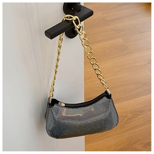 Close-up of glitter finish shoulder bag with chunky gold chain on a door handle
