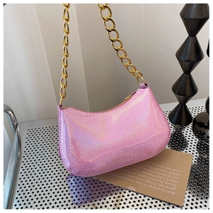 Pink glitter underarm bag with gold chunky chain strap and crescent shape detail