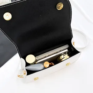 Interior view showing the capacity of a chic black and white crossbody flap handbag