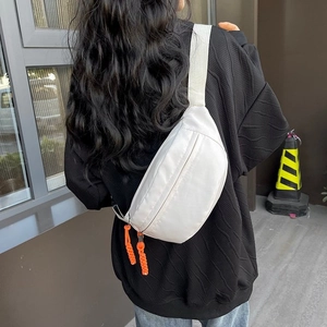 White minimalist waterproof nylon chest bag with orange contrast zipper puller for unisex