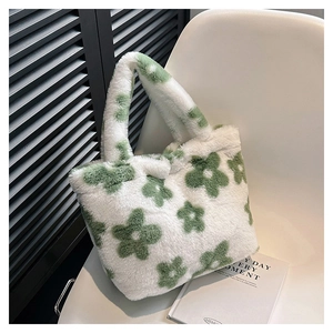 Detailed close-up of fluffy white faux fur tote bag with green floral pattern on chair