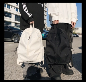 Close-up of minimalist travel backpack with side drawstring pocket and durable fabric