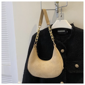 Detail of khaki crescent underarm bag with gold chain and premium suede texture