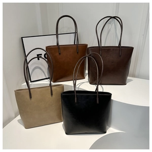 Minimalist vintage bucket tote bags in beige, caramel, brown, and black leather colors