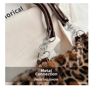Detail of the leopard faux fur tote with metallic ring chain and brown leather strap