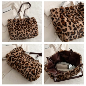 Detail of leopard print faux fur tote bag showing metal chain strap and spacious interior
