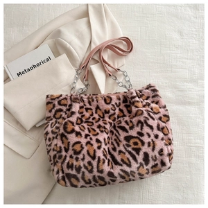 Detail of pink leopard faux fur handbag with silver chain and chic faux leather handle