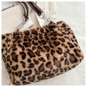 Detailed close-up of plush leopard print faux fur texture and silver chain strap handle