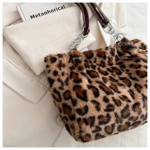 Detail of leopard print faux fur tote bag with silver chain and leather shoulder strap