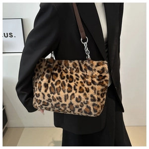 Detail of plush leopard print faux fur shoulder bag with silver chain and leather strap