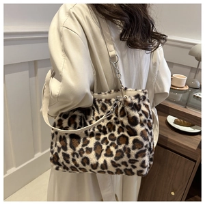 Detail shot of the plush leopard print faux fur tote bag with a white leather strap
