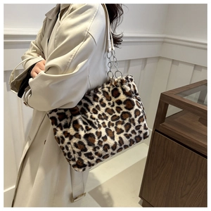 Detail view of the leopard print plush tote bag with its faux fur texture and chain strap