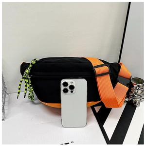 Detail of color-block nylon chest bag with phone for size reference and neon accents