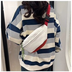 Detail of white and red casual fanny pack with contrast cord zippers and adjustable strap