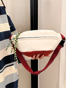 Fashionable two-tone waist bag in cream and dark red with woven pull cords for outdoor use