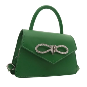 Emerald green crossbody bag with rhinestone bow buckle and top handle in a matte finish