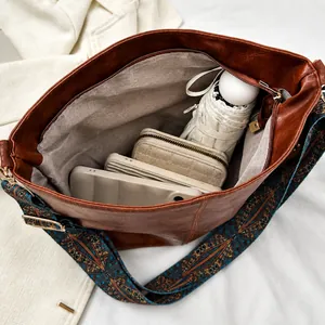 Brown vintage PU leather shoulder bag showing large capacity storage for daily essentials