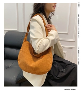 Detail of caramel corduroy crescent bag showing wide strap and SPORT patch detail