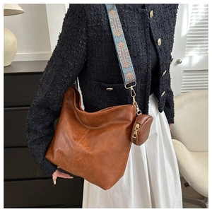 Brown large capacity hobo bag with vintage patterned wide strap and mini coin purse charm