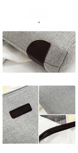 Close-up of linen texture tote bag with brown leather trim and fashion brand patch