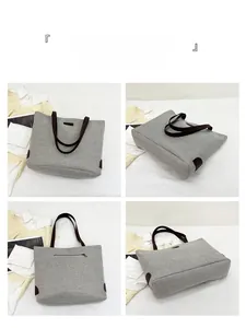 Detail view of large grey linen tote bag featuring dark brown straps and back zipper pocket
