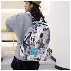 Street style graffiti backpack detail shown on model in casual urban setting