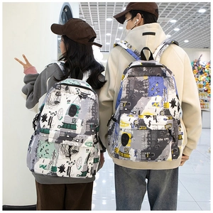 Rear view of couple wearing Japanese graffiti backpacks with bold street style prints