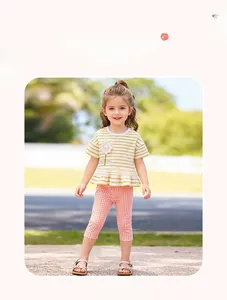 Detail of girls summer set with yellow striped top, sunflower applique and plaid leggings