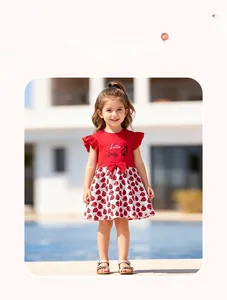 Detail of girls' summer dress featuring red ladybug print and elegant sleeve ruffles
