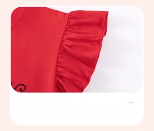Detailed view of red cotton knit dress sleeve with delicate lotus leaf ruffles and embroidery