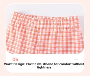 Close-up of girls orange checkered pants featuring elastic waistband and wavy stitching