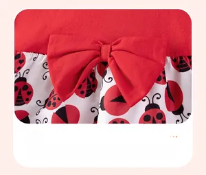 Detail of red cotton girls dress featuring a 3D bow and ladybug print pattern