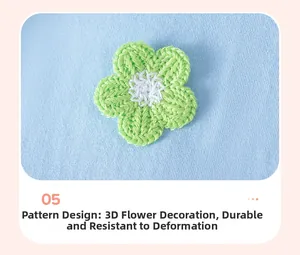 Close-up of a 3D green crochet flower on a light blue cotton knitted girl dress