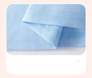 Detailed macro view showing the neat double-needle stitching on light blue cotton dress hem