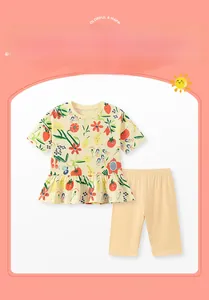 Detail of floral girls summer cotton set with ruffle hem and fruit pattern print