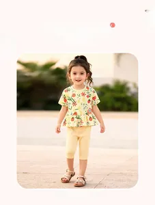 Detail of floral yellow cotton toddler set with ruffled hem and matching leggings