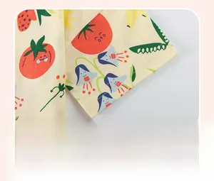 Detailed view of the toddler shirt sleeve with double-stitched hem and fruit pattern