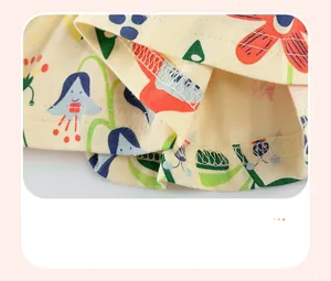 Close-up of the double-stitched hemline on girls cotton dress with floral print