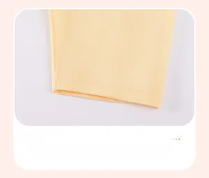 Close-up of cotton girl trousers showing durable leg cuff stitching and soft knit fabric