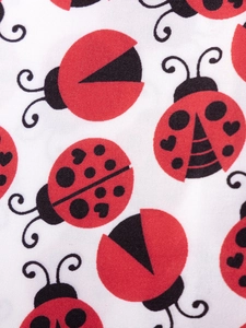 Cute ladybug print dress for children made of soft white cotton with heart pattern