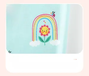 Detail of baby girl clothing fabric featuring cute rainbow and sunflower digital prints
