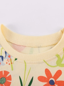 Little girl floral summer outfit with colorful flower prints on pale yellow cotton fabric