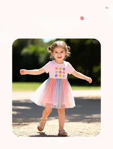 Close-up of rainbow tulle skirt and floral print on pink cotton dress for girls