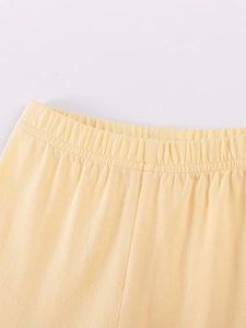 Pastel yellow cotton baby shorts with elastic waistband and durable double-stitched details