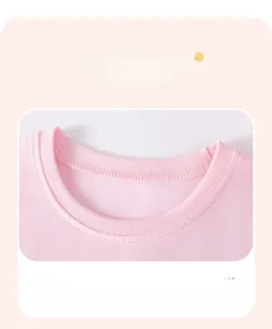 Close-up of pink round neck with fine stitching and ribbed texture on cotton dress